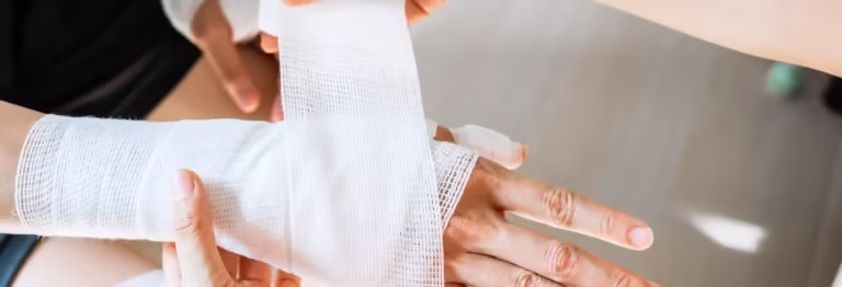 Hand wrapped in gauze after a dog bite injury in Arizona.